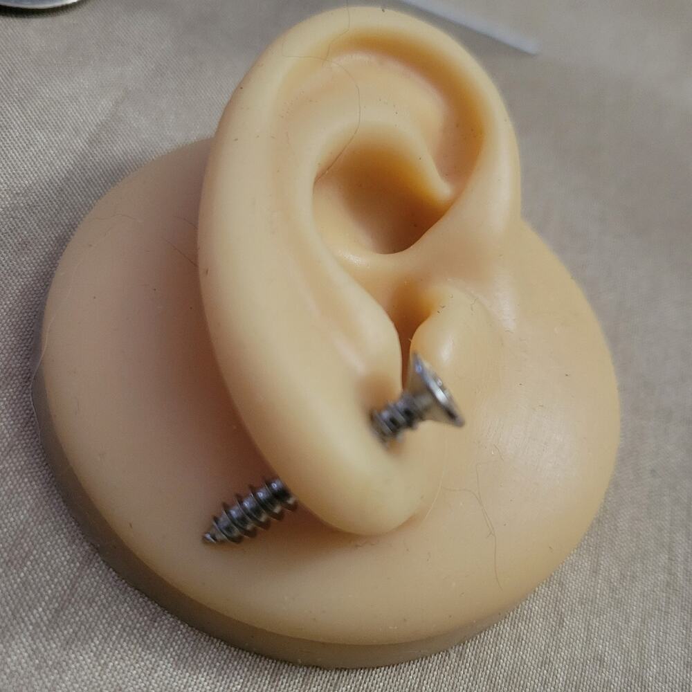 Silver screw shaped illusion post earrings